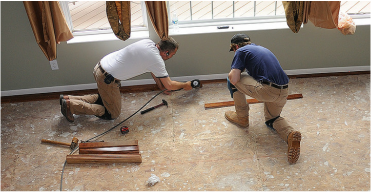 Handyman installing flooring in Fort Wayne